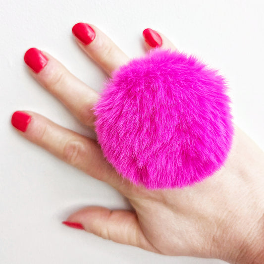 Large Fluffy Pink pom pom ring modelled on left hand