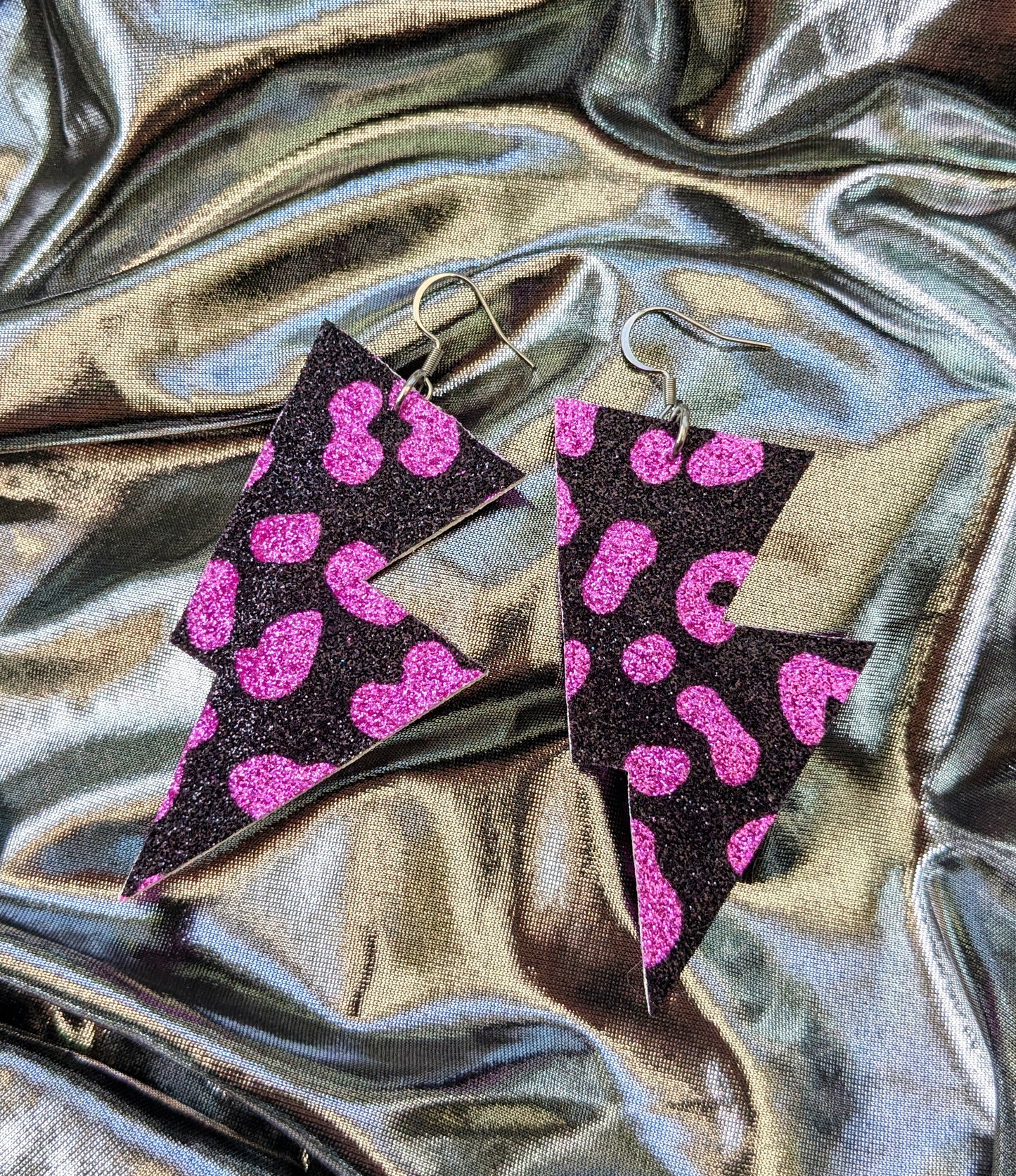 Medium leopard print lightning bolt earrings in pink and black glitter