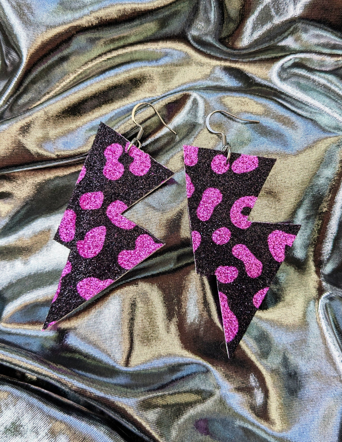 Medium leopard print lightning bolt earrings in pink and black glitter