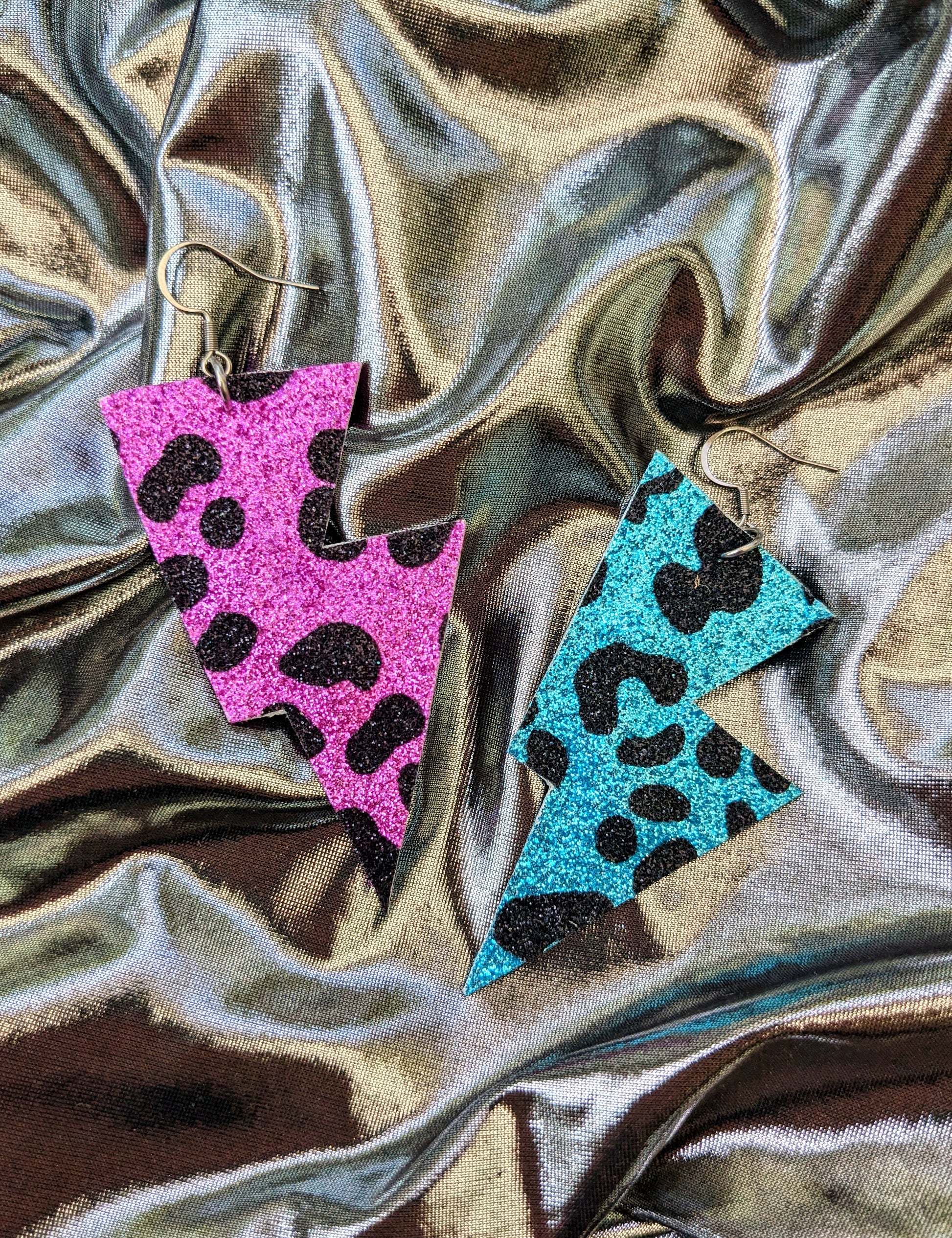 Medium leopard print lightning bolt earrings in turquoise, pink and black glitter