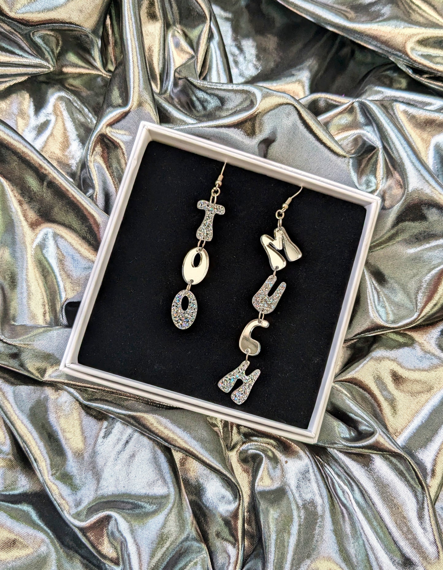 'Too Much' letter dangle earrings in silver acrylic