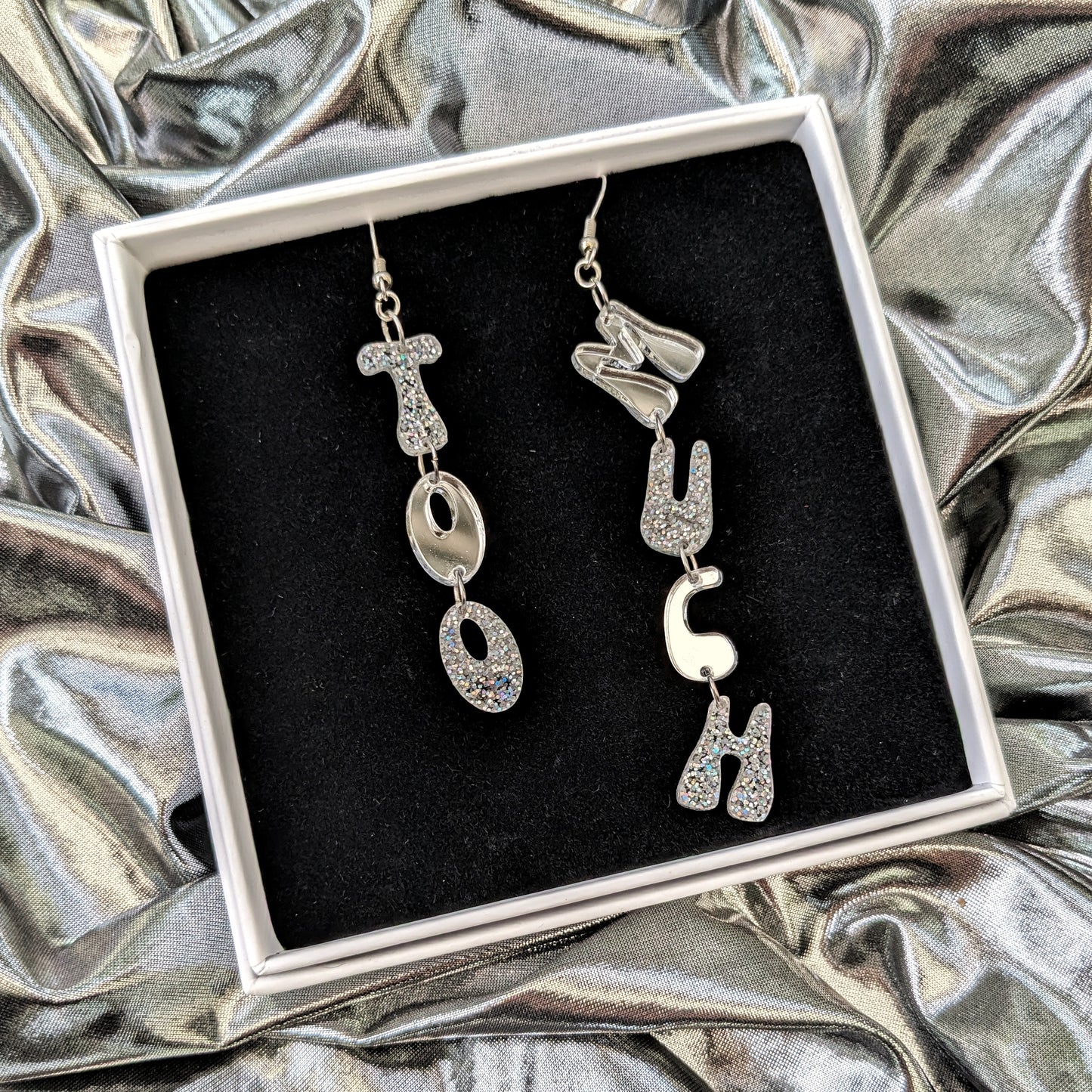 'Too Much' letter dangle earrings in silver acrylic