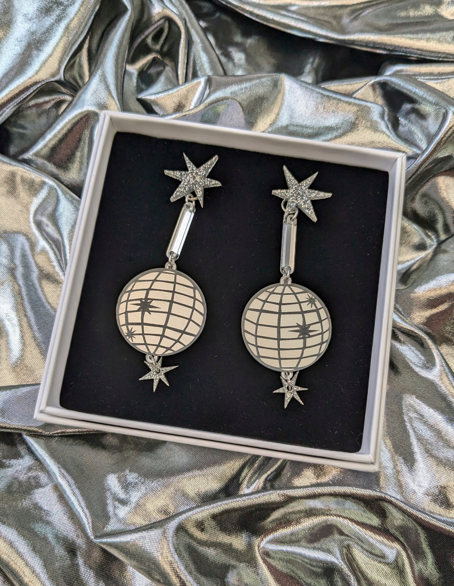 Large acrylic mirror effect disco ball earrings, boxed on a silver fabric background