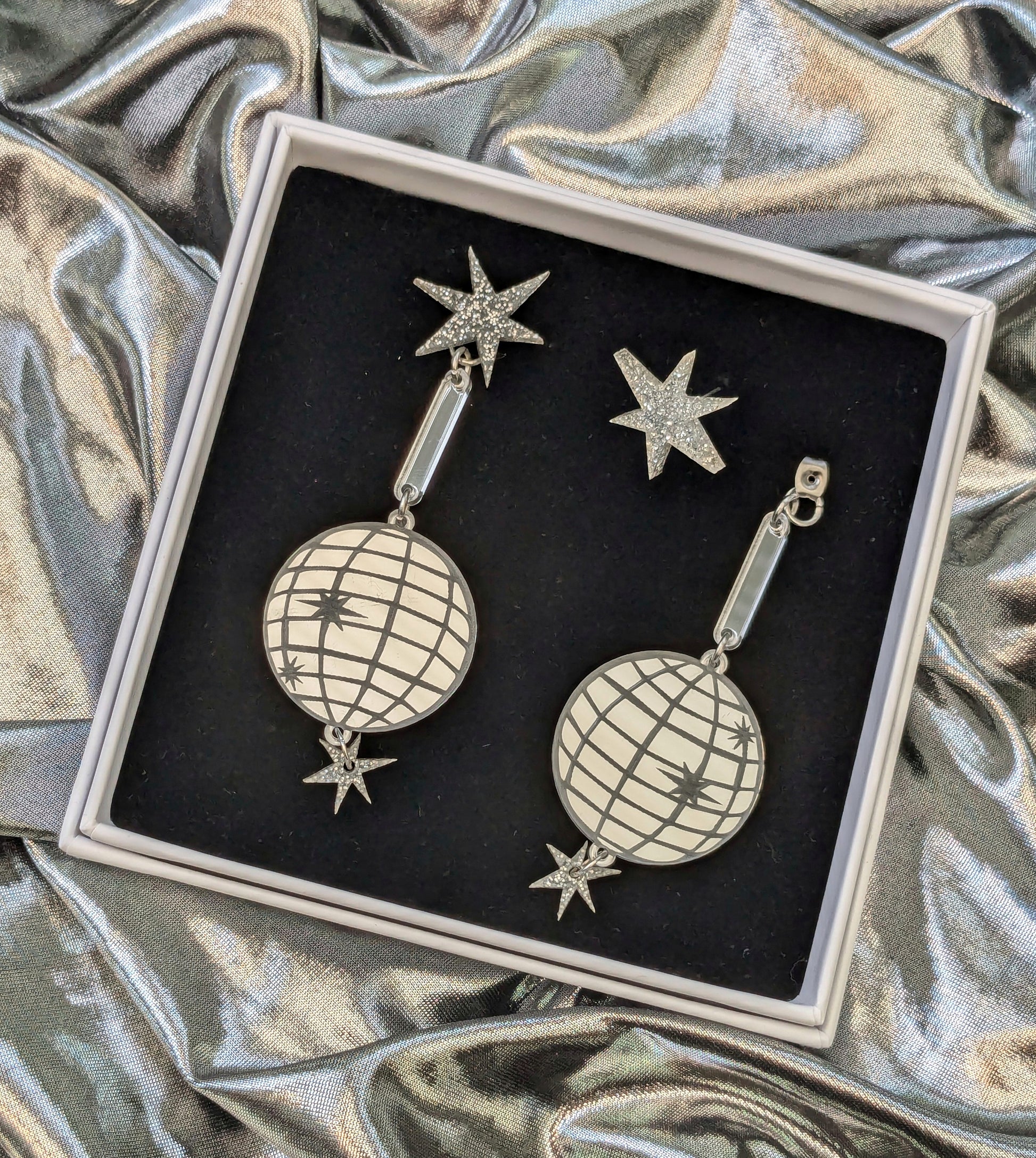 Large acrylic mirror effect disco ball earrings, boxed on a silver fabric background