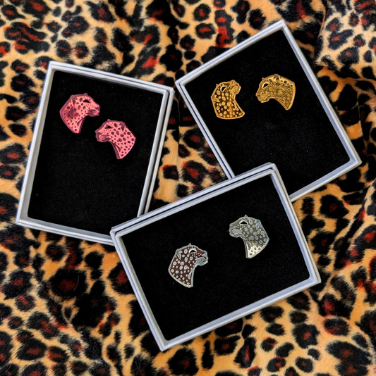 Handmade laser Leopard Heads in Silver, Gold or Pink Mirrored Acrylic with intricate leopard spot detailing. Pictured boxed on a leopard print background