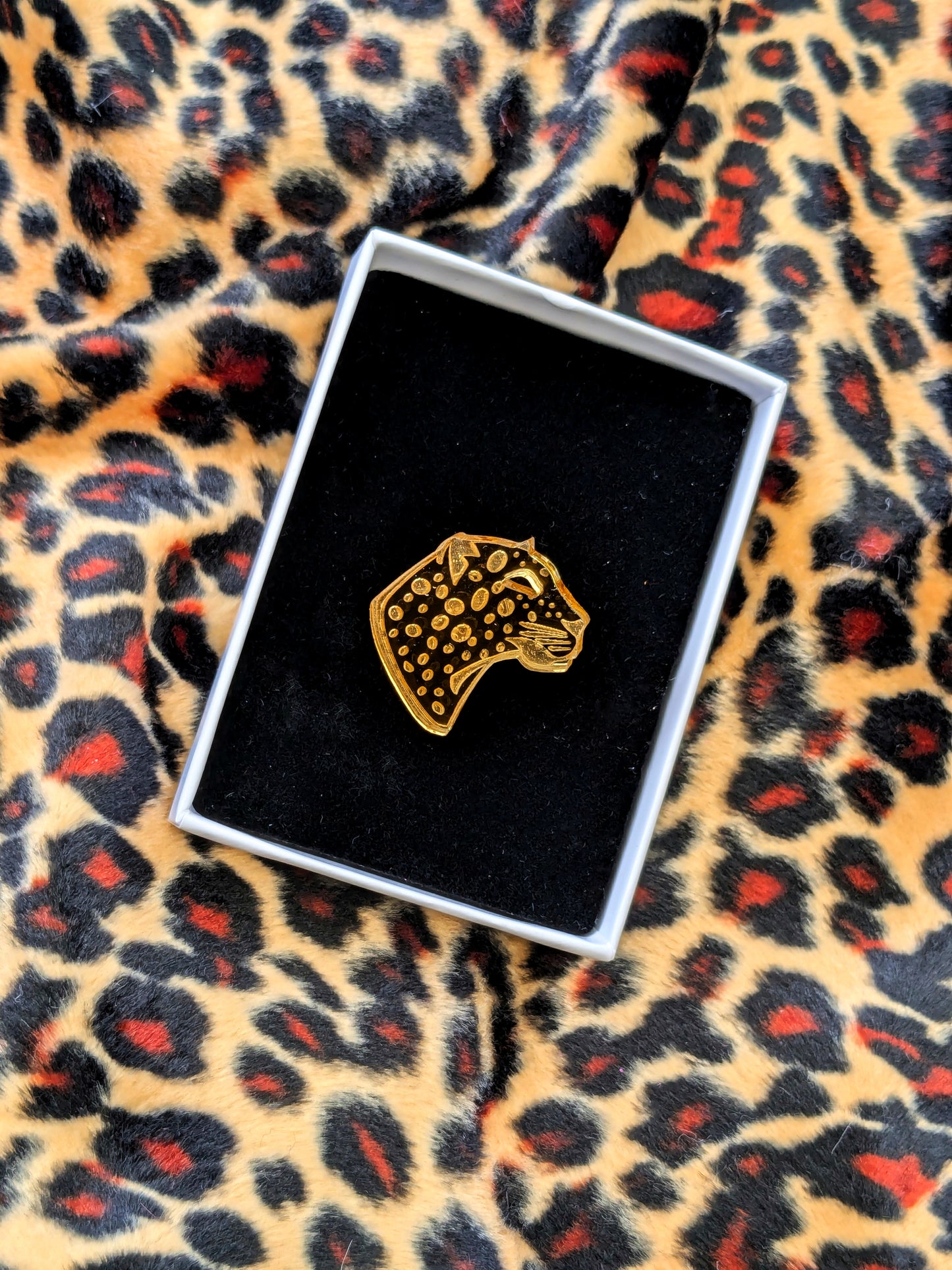 Handmade laser Leopard Heads in Gold Mirrored Acrylic with intricate leopard spot detailing.