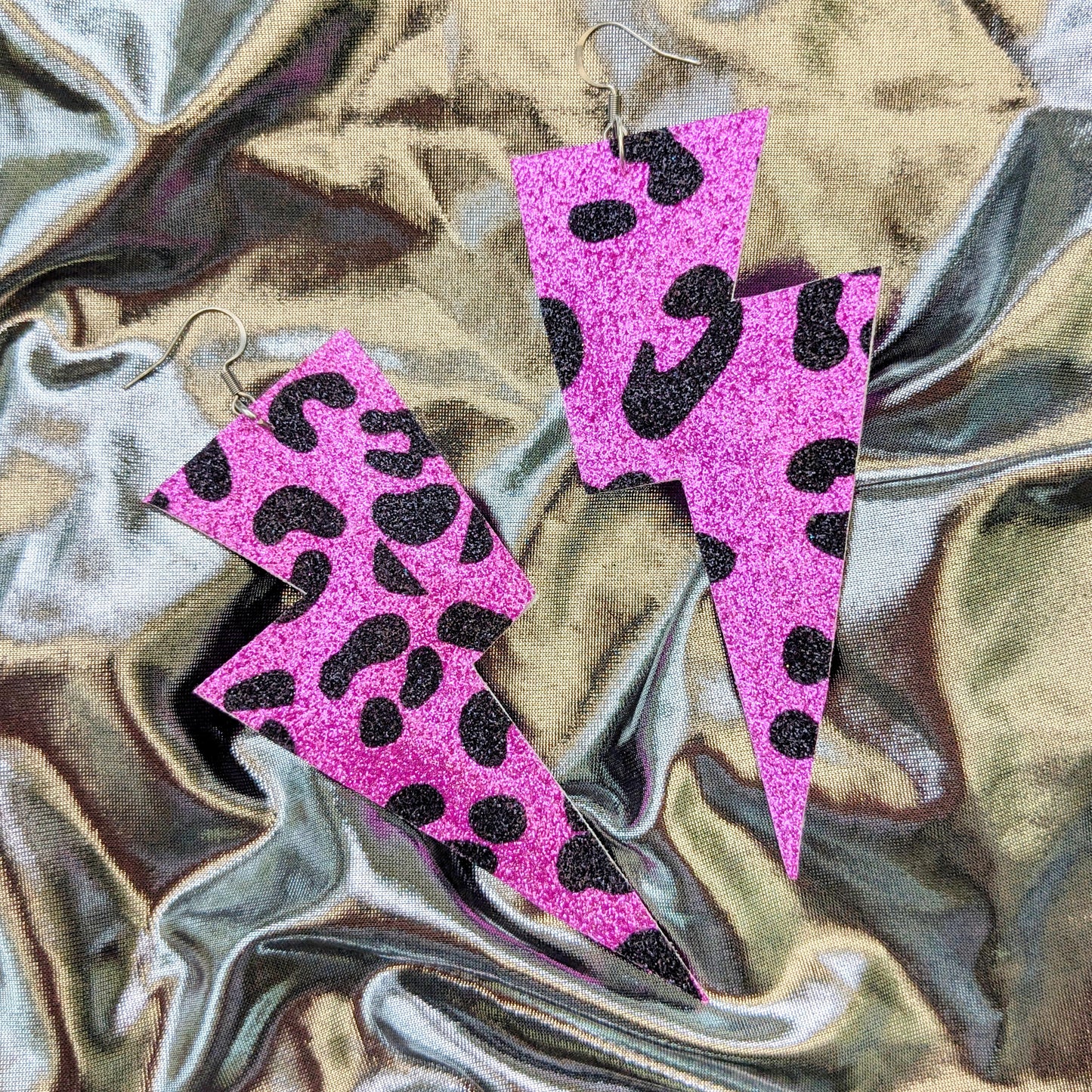 Large leopard print lightning bolt earrings in pink and black glitter