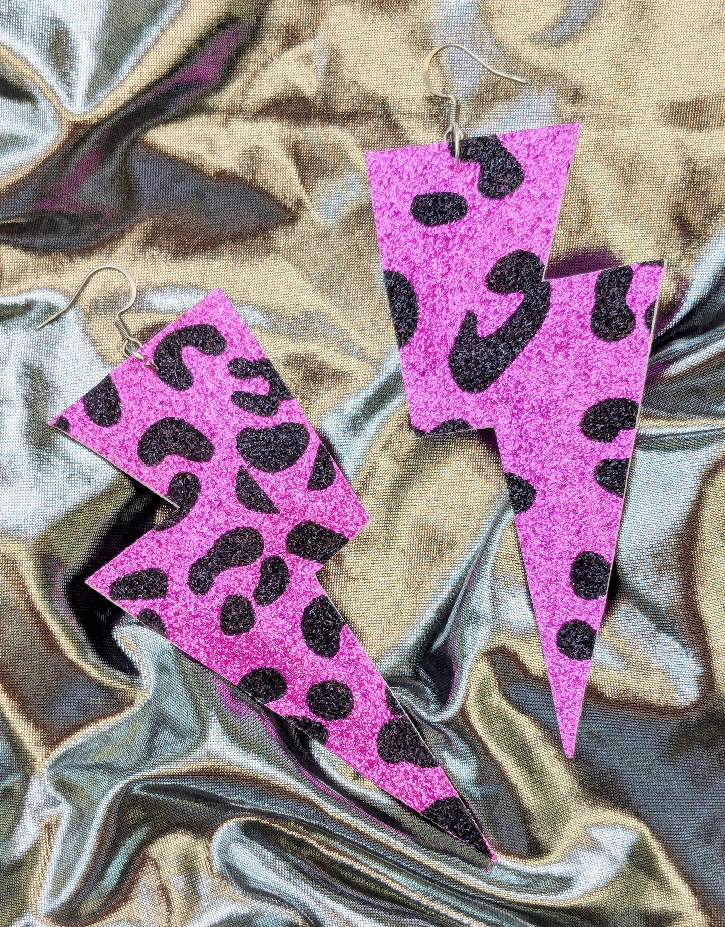 Large leopard print lightning bolt earrings in pink and black glitter