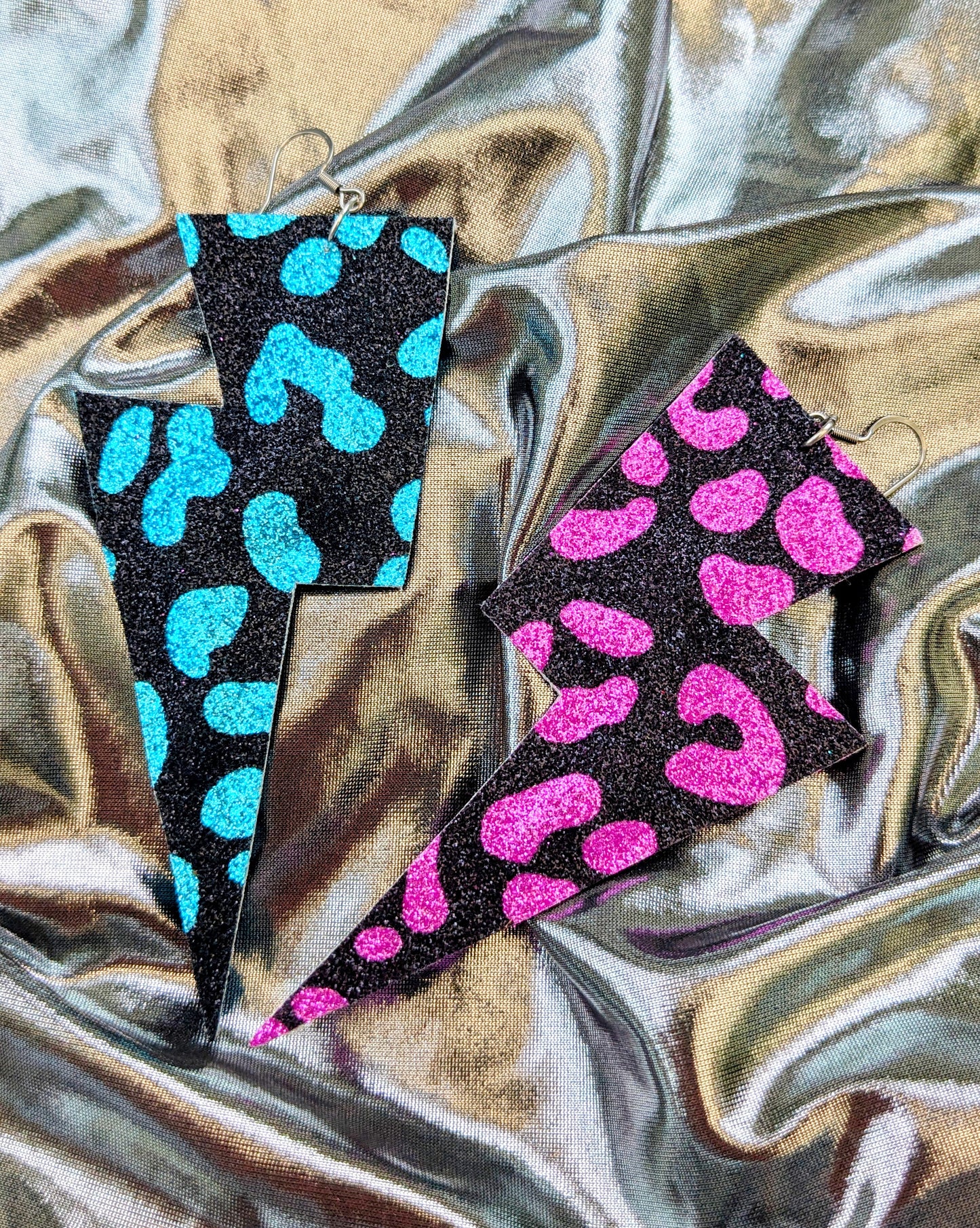 Large leopard print lightning bolt earrings in turquoise, pink and black glitter