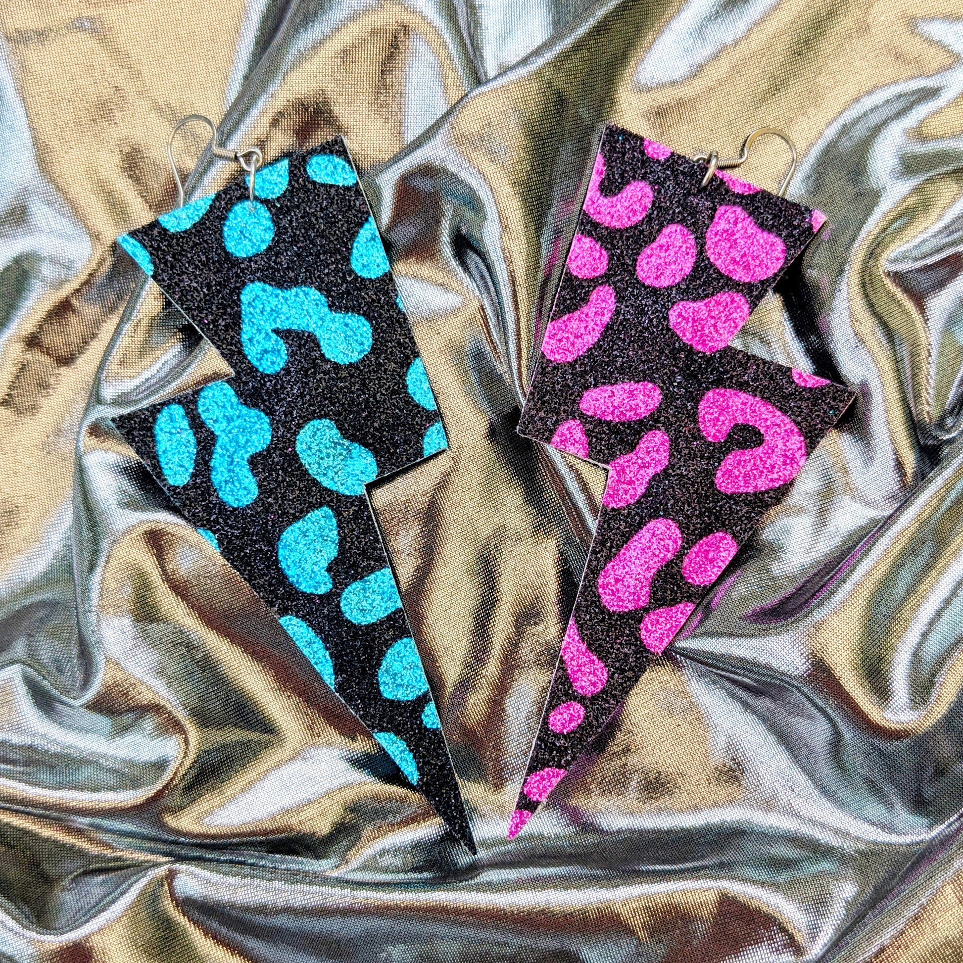 Large leopard print lightning bolt earrings in turquoise, pink and black glitter