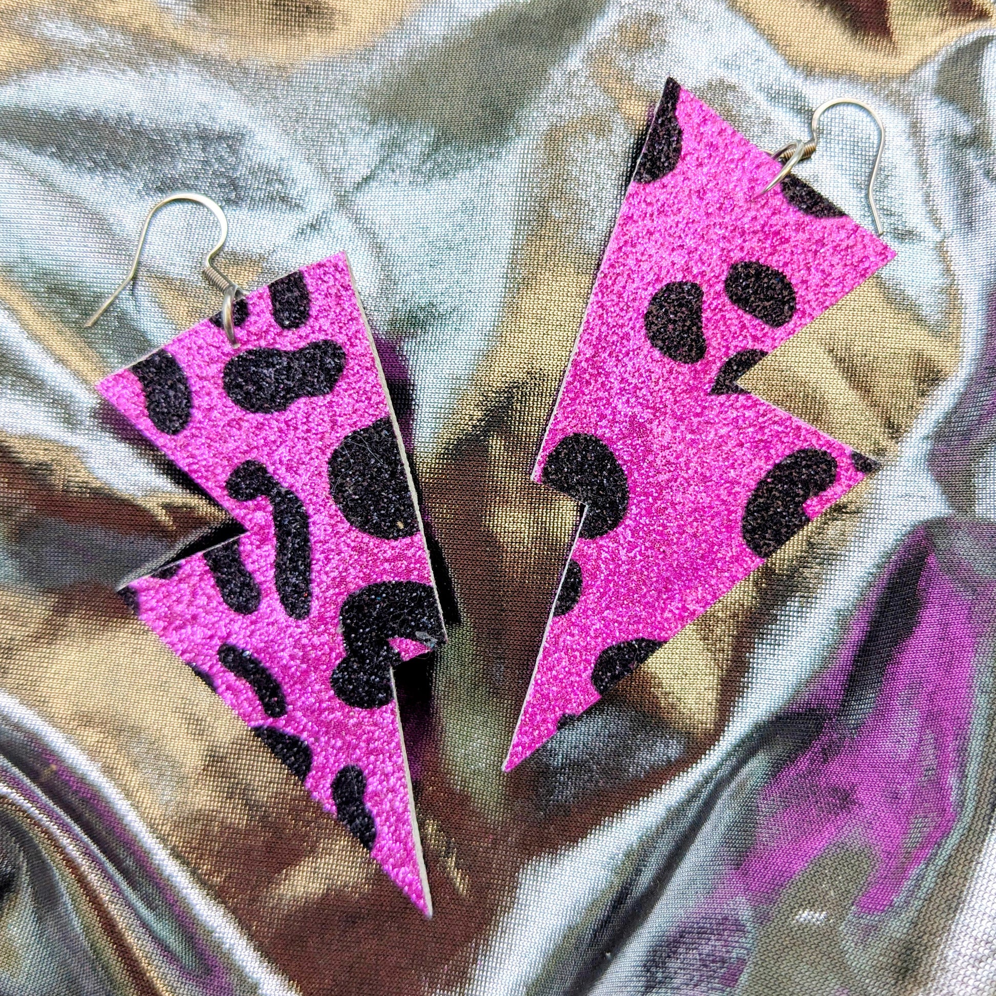 Medium leopard print lightning bolt earrings in pink and black glitter