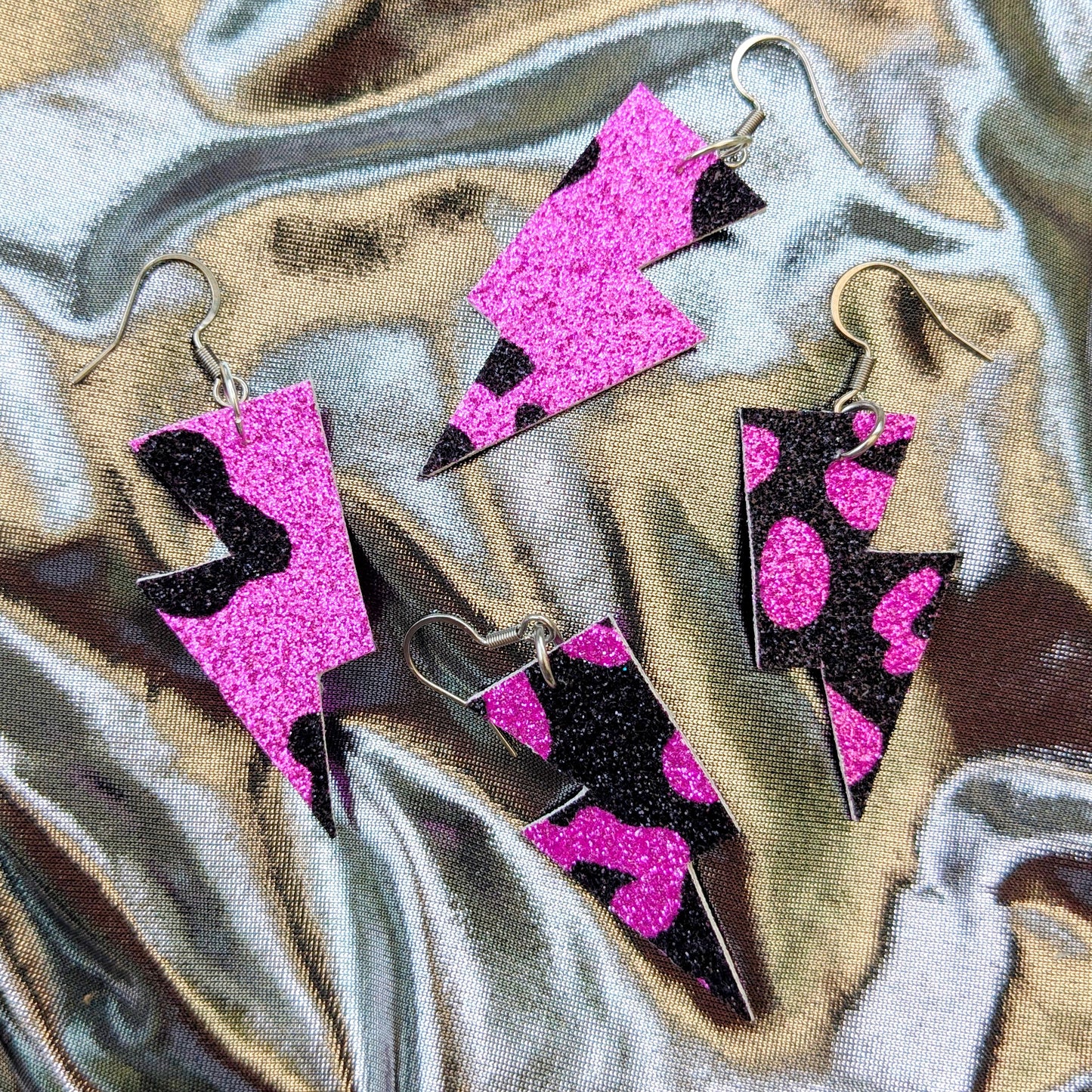 small leopard print lightning bolt earrings in pink and black glitter fabric