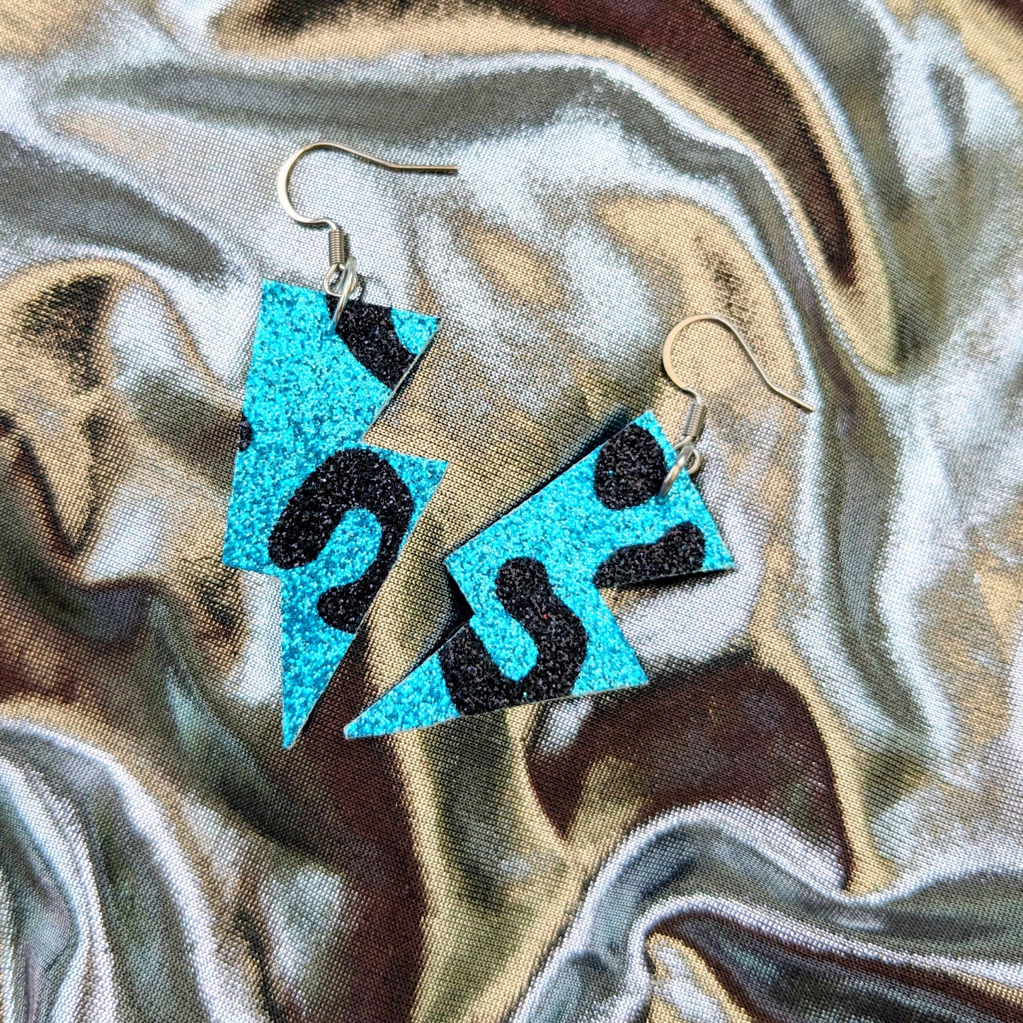 small leopard print lightning bolt earrings in turquoise and black