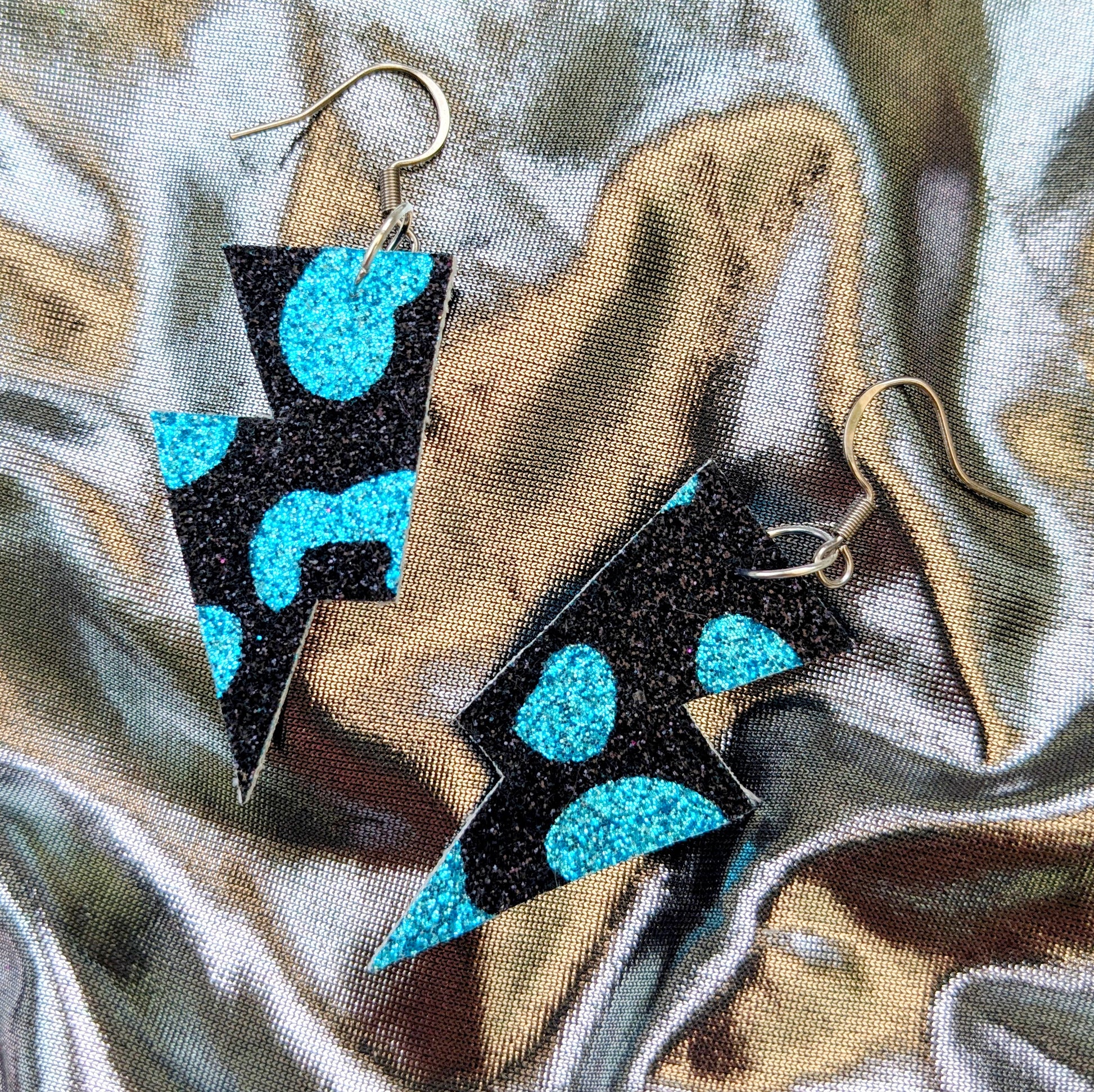 small leopard print lightning bolt earrings in turquoise and black