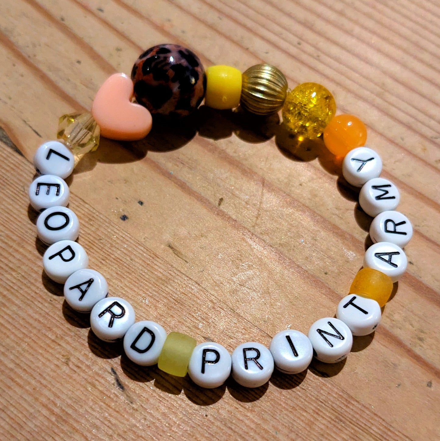 Friendship Bracelet in gold and yellow beads with letter beads spelling Leopard Print Army