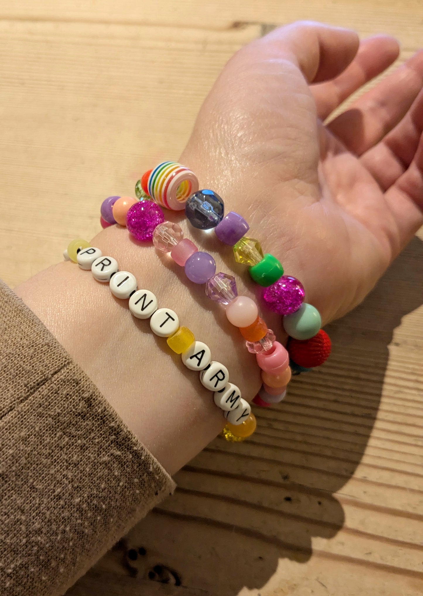 Hand modelling 3 friendship bracelets 'Too Much', 'ADHDAF' and 'Leopard Print Army'