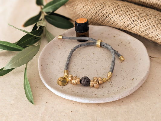 Resilience – Light Grey Aromatherapy Essential Oil Diffuser Bracelet with Lava Bead and Gold Hematite Stones