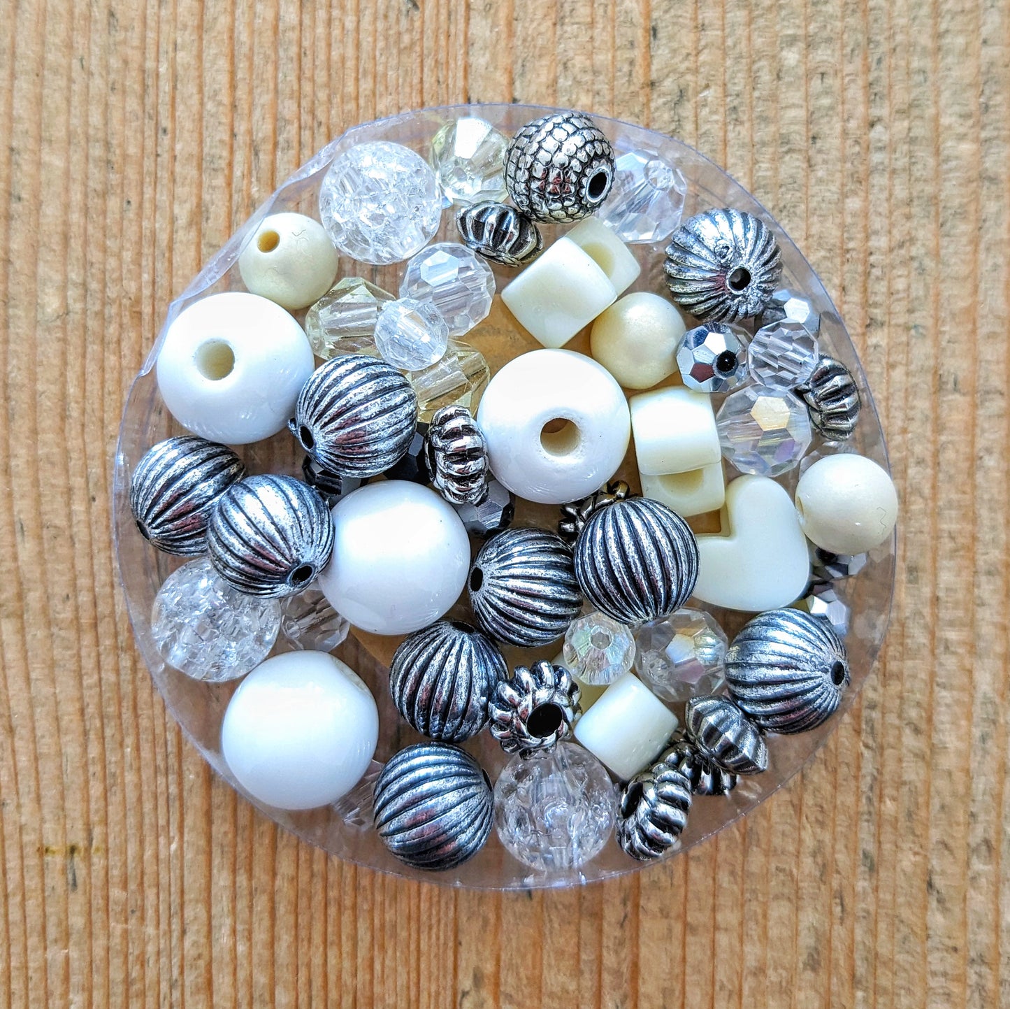 Variety of colourful glass and acrylic beads in silver and cream